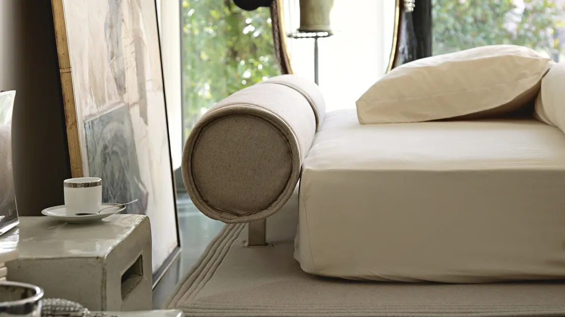 Fabric bed with Flamingo roller headboard by Noctis.