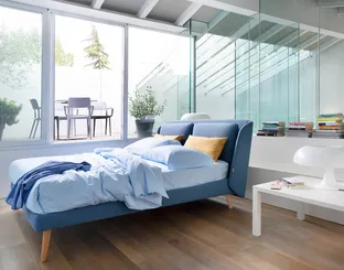 Fabric bed with Hello headboard by Noctis.