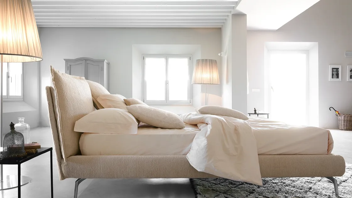 Modern bed with So Pop fabric headboard by Noctis.