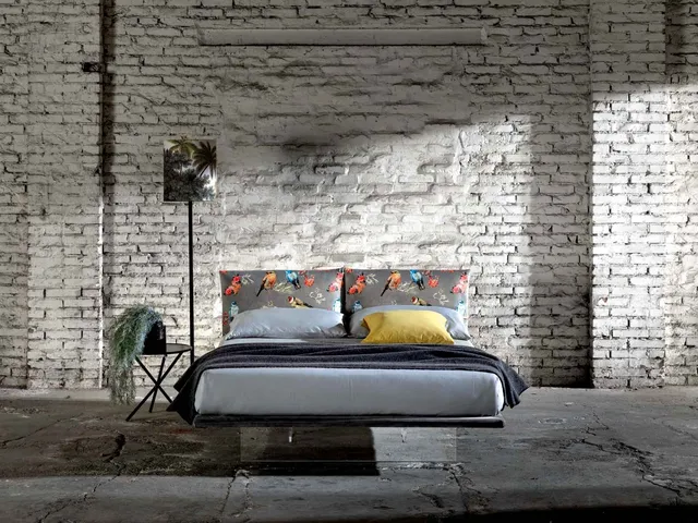 Double bed in fabric with a plexiglass base that makes it appear suspended like the Veneran Wire.