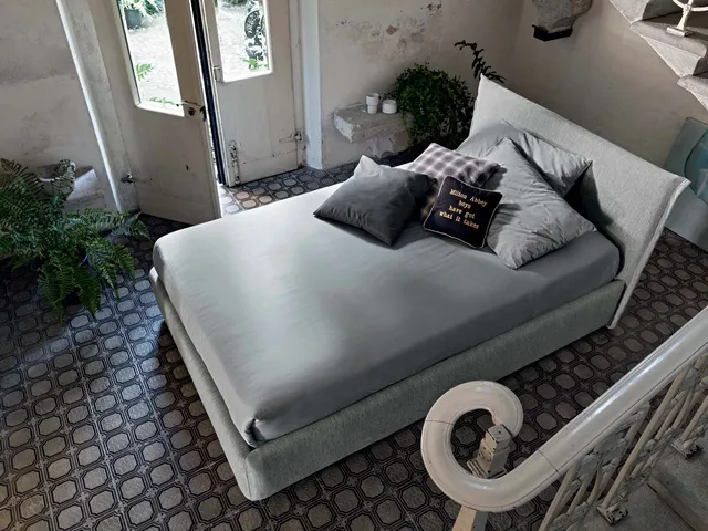 Upholstered fabric bed with Twin Line headboard by Veneran.