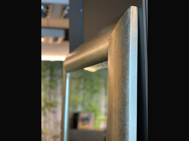 Handcrafted mirror. Metallic effect wooden frame