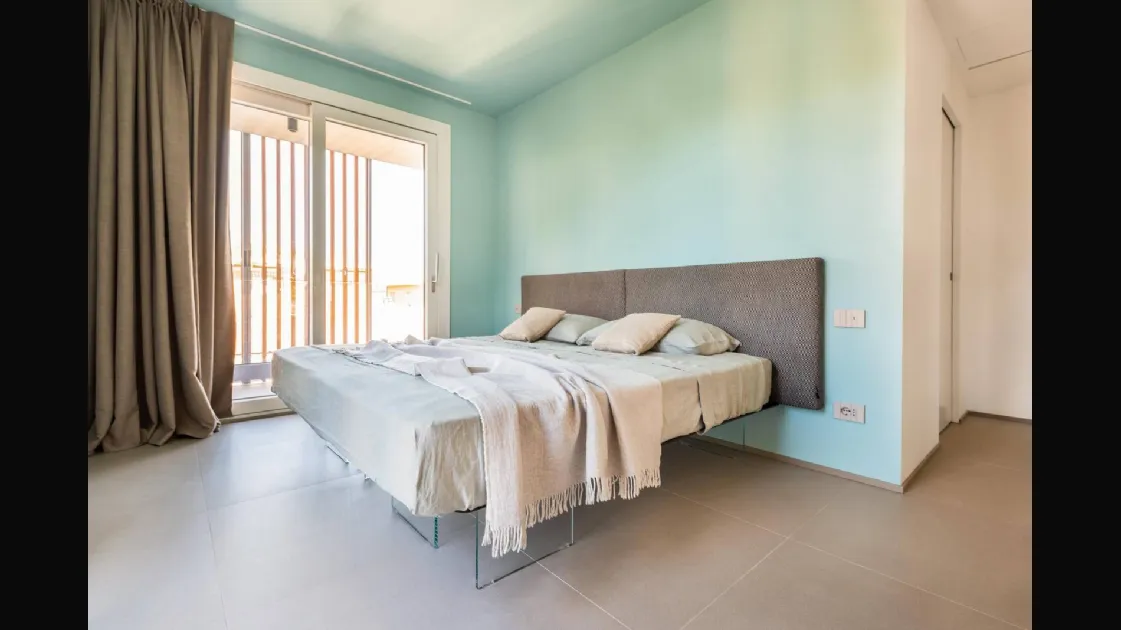 Air 1507 bed with upholstered fabric headboard by Lago.