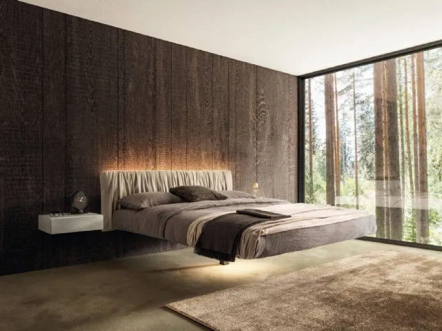 Suspended bed Floats 1631 with pleated leather headboard by Lago.