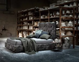 Upholstered fabric bed with an imposing quilted headboard from the Momà collection by Veneran.