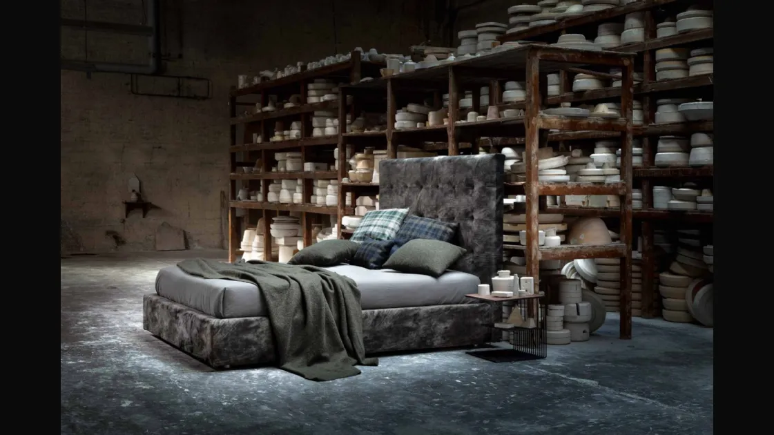 Upholstered fabric bed with an imposing quilted headboard from the Momà collection by Veneran.