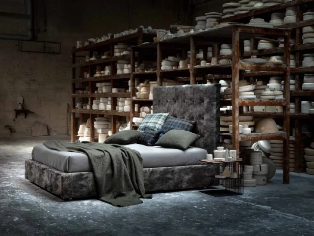 Upholstered fabric bed with an imposing quilted headboard from the Momà collection by Veneran.
