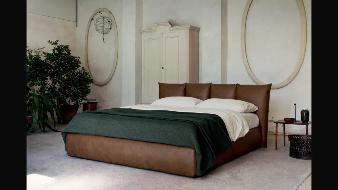 Vintage faux leather bed with a wraparound headboard and Plissé storage box by Veneran.