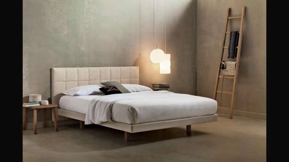 Double bed in eco-nubuck. Suspended headboard with headrest applied to the wall by Veneran.