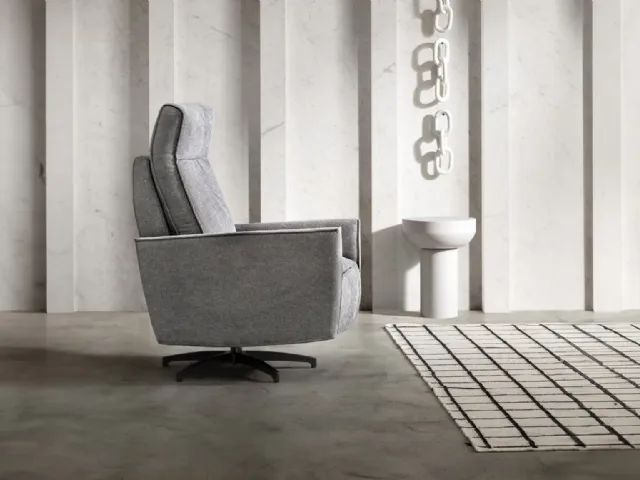 Gaspy Relax fabric armchair with footrest by Samoa, reclining.